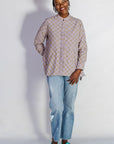 Model wearing linen top with small flower print.