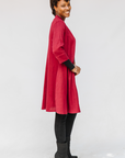 Model wearing burgundy linen dress.