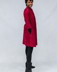 Model wearing burgundy linen dress.