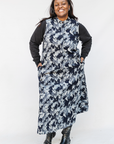 Model wearing navy and gray abstract print maxi dress.