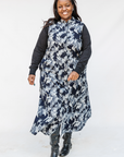 Model wearing navy and gray abstract print maxi dress.