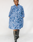 Model wearing blue shaded leaf print dress.