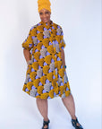Model wearing orange and purple dress.