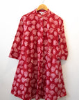 Display of red dress with pink flowers.
