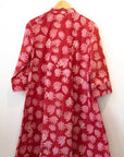 Display of red dress with pink flowers.