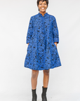 Model wearing black and blue floral dress.