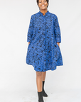 Model wearing black and blue floral dress.