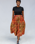 Model wearing multicolored dot print skirt.