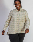 Model wearing long sleeved shirt with small owl print.