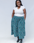 Model wearing aqua, black and white culottes.