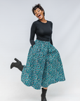 Model wearing aqua, black and white culottes.