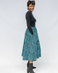 Model wearing aqua, black and white culottes.