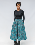 Model wearing aqua, black and white culottes.