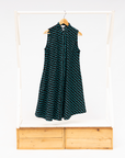 Display of sleeveless black dress with teal moon design.