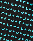 Close up display of sleeveless black dress with teal moon design.