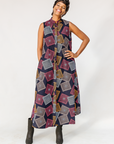Model wearing pink, orange, white and black geometric print dress.