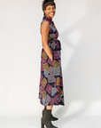 Model wearing pink, orange, white and black geometric print dress.