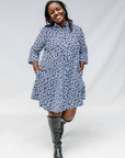 Model wearing blue and white swirl print dress.
