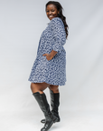 Model wearing blue and white swirl print dress.