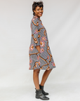 Model wearing black and white light bulb print dress.