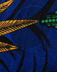 Close up display of blue sleeveless dress with orange and green print.