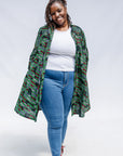Model wearing green camo print like dress.