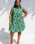 Model wearing sleeveless dress with green and blue snail print.