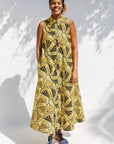 Model wearing yellow and black sleeveless maxi dress.