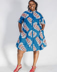 Woman wearing a blue patterned dress on a white background