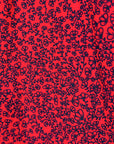 detail of a red and black leaf design dress
