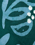 Close up display of green and blue floral batik dress, fabric.