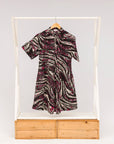 Display of pink, black and white glitter print dress.