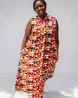 Model wearing geometric print dress.