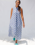 Model wearing blue and white mosaic print dress.