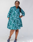 Model wearing green and blue floral batik dress.