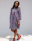 Model wearing purple and blue batik dress.