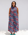 Model wearing grey, red and black dragonfly print dress.
