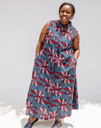 Model wearing grey, red and black dragonfly print dress.