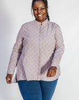 Model wearing linen top with small flower print.