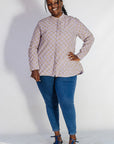Model wearing linen top with small flower print.