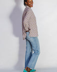 Model wearing linen top with small flower print.