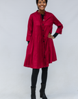 Model wearing burgundy linen dress.