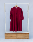 Display of burgundy linen dress.