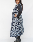 Model wearing navy and gray abstract print maxi dress.