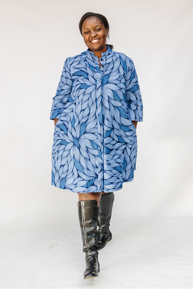 Model wearing blue shaded leaf print dress.