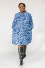 Model wearing blue shaded leaf print dress.