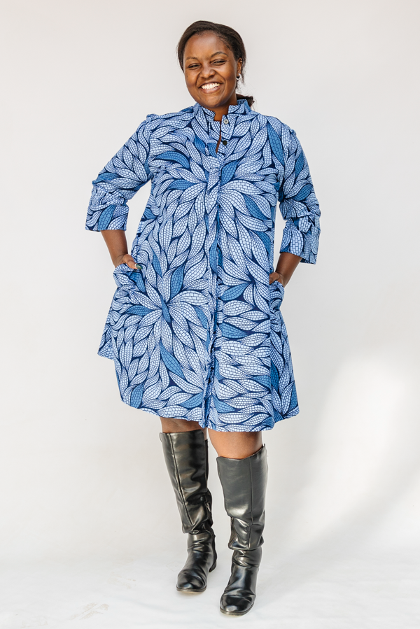 Model wearing blue shaded leaf print dress.