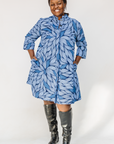 Model wearing blue shaded leaf print dress.