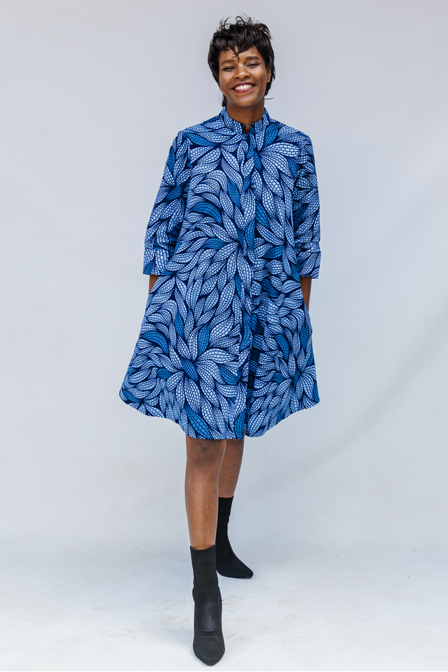 Model wearing blue shaded leaf print dress.