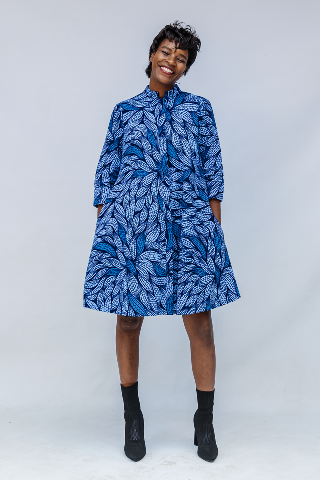 Model wearing blue shaded leaf print dress.